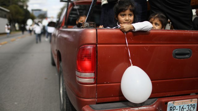 Girls ride in a truck during a march for peace near the U.S./Mexico border.