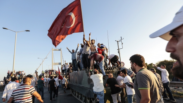 Erdogan supporters stand on tank after coup attempt