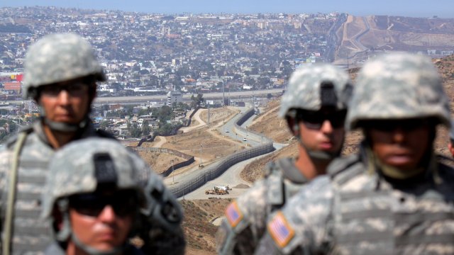 National Guardsmen stand in formation along the U.S.-Mexico border.