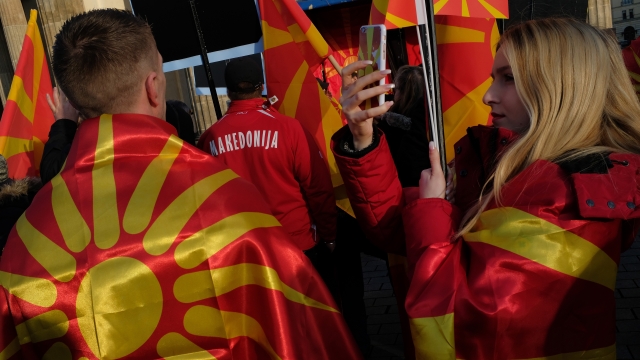 People holding Macedonian flags