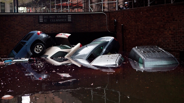 Cars floating in water following Superstorm Sandy.