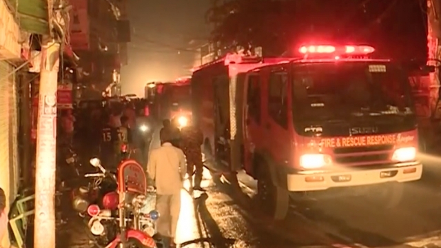 Fire trucks line a street in Bangladesh's capital