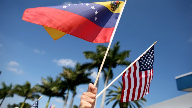A protester holds Venezuelan and American flags
