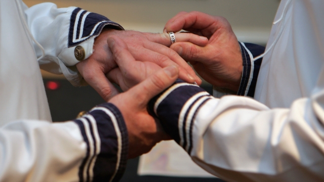 A gay couple exchanges rings at their wedding ceremony