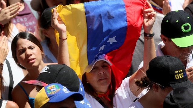 A woman holds a Venezuelan Flag