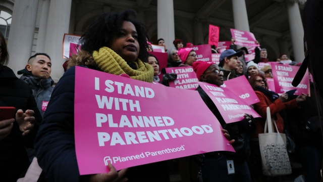 Protesters holding signs in support of Planned Parenthood