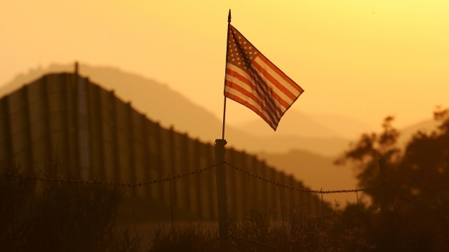 A U.S. flag near the US-Mexico border fence