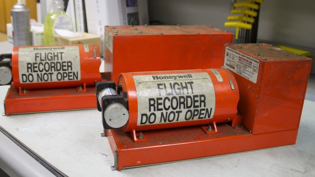 Two flight recording devices sit on a table at the National Transportation Safety Board's laboratory in Washington, DC