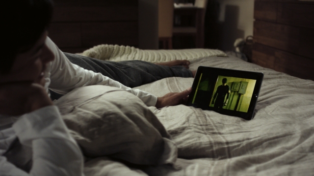 Person watches Netflix in bed