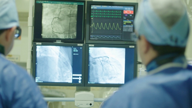 Doctors look at heart monitors