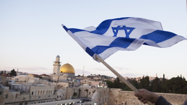 Israelis wave their national flag