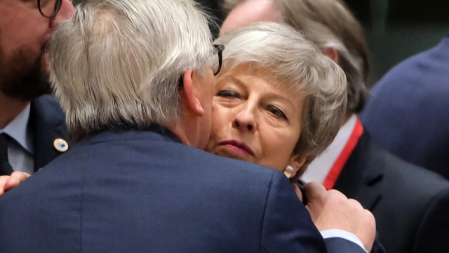 European Commission President Jean-Claude Juncker greets British Prime Minister Theresa May