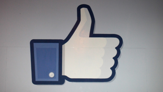 A thumbs up 'like' sign stands at the entrance to Facebook headquarters.