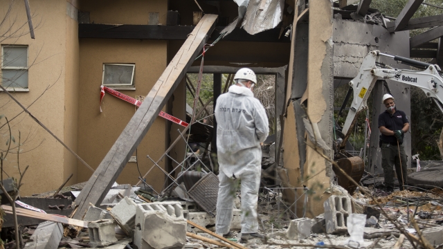 Officials inspect a home in Israel that was bombed early Monday morning.