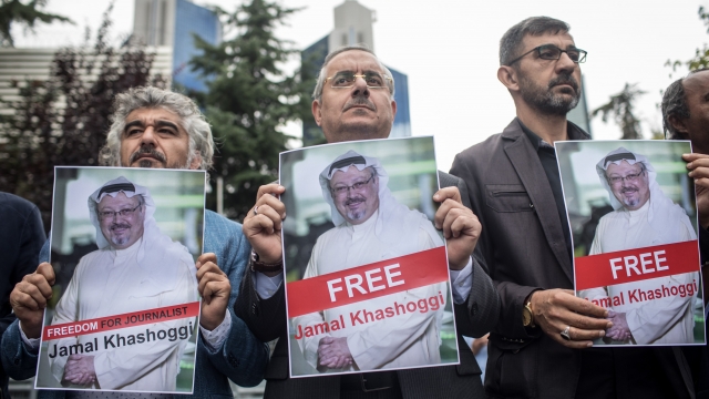 People hold posters of Saudi journalist Jamal Khashoggi