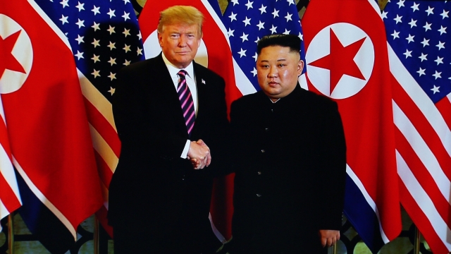 President Donald Trump standing beside North Korean leader Kim Jong-un.