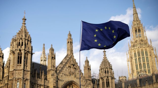 An EU flag in front of the Houses of Parliament