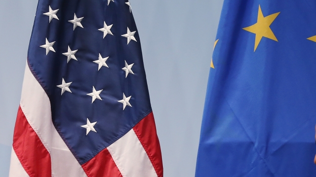 An American flag and a European Union flag.