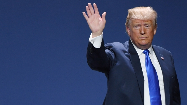 President Trump waves at a crowd.