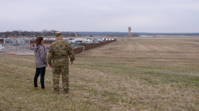 Col. Vance Goodfellow shows Newsy reporter Lindsey Theis an overview of the damage at Offutt Air Force base.