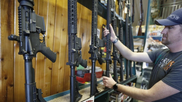 Assault rifles are displayed at a gun store