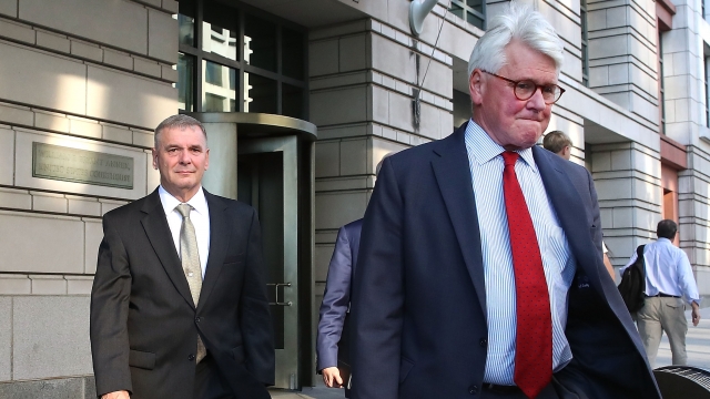 Greg Craig leaves a federal courthouse