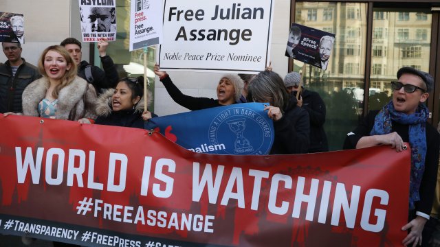Demonstrators protest the arrest of Julian Assange