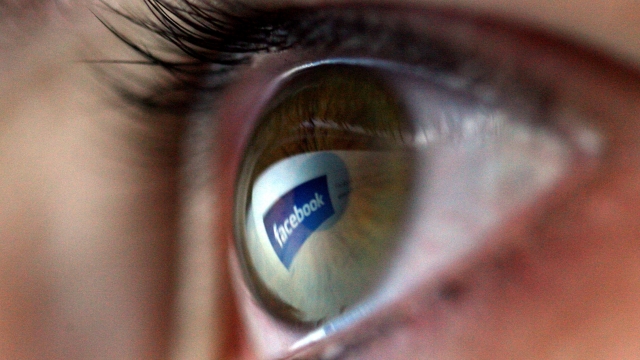 Facebook logo reflected on an eye