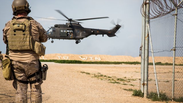 A U.S. soldier watches a helicopter land