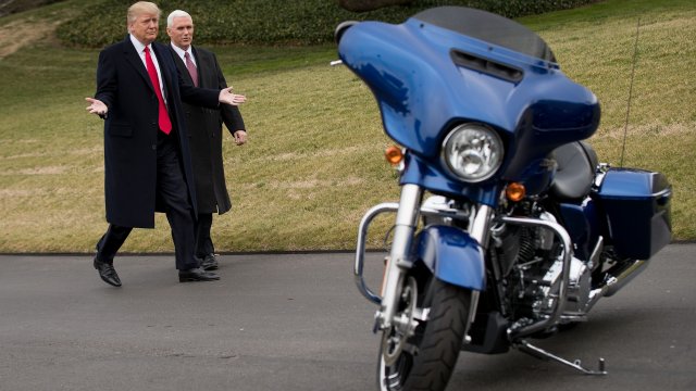 President Donald Trump and Vice President Mike Pence check out a Harley Davidson motorcycle