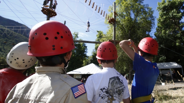 Boy Scouts wait in line to climb on a ropes course