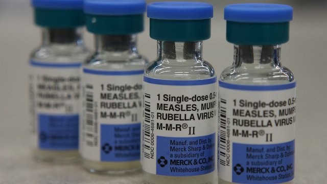 Vials of measles, mumps and rubella vaccine are displayed.