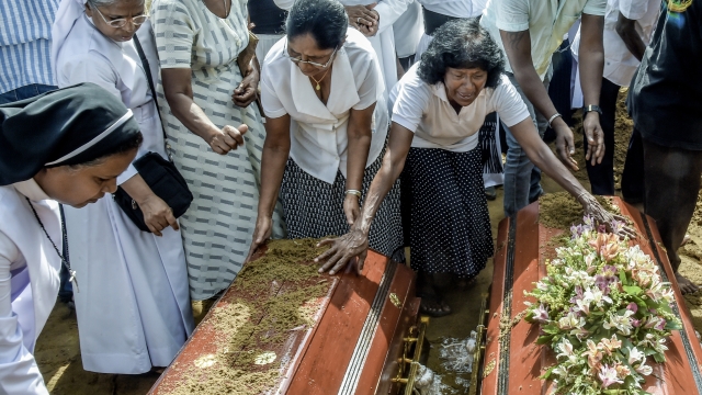 Sri Lankan's mourn during a funeral for some of the people killed Sunday