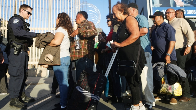 Immigrants in line waiting for cross into U.S.