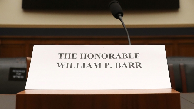 A placard for Attorney General William Barr on a table