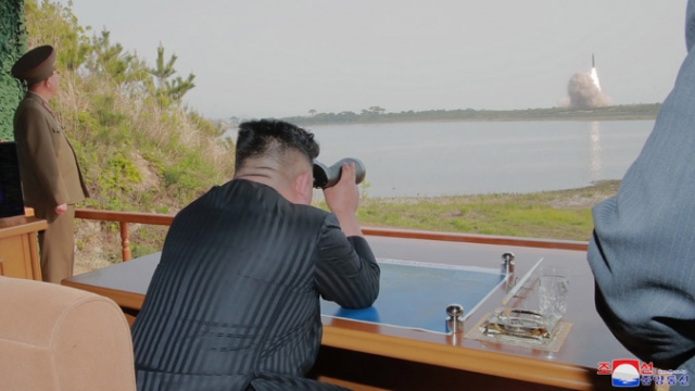 North Korean leader Kim Jong-un watches a missile launch