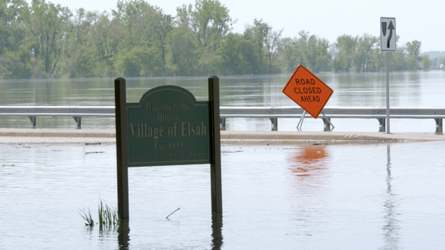 A sign sits in floodwaters