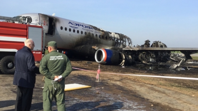 Teams look at what's left of the plane that crashed in Moscow