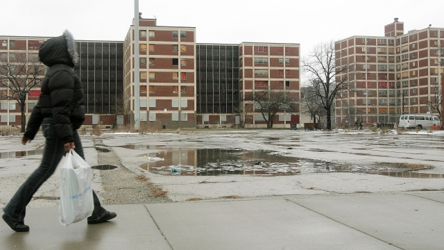 Person walks past Chicago public housing buildings