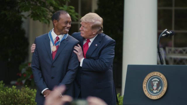 President Donald Trump gives Tiger Woods the Medal of Freedom at an event at the White House.