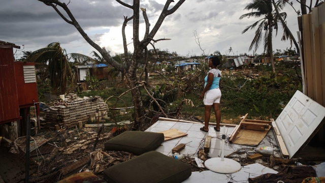A resident stands on her property about two weeks after Hurricane Maria hit Puerto Rico.