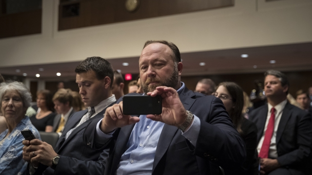 Alex Jones of InfoWars live streams a Senate Intelligence Committee from his phone on Sep. 5, 2018