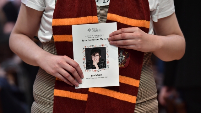 A mourner wearing a Hogwarts scarf holds the order of service for the funeral for journalist Lyra McKee