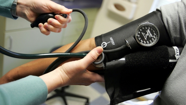 A patient has their blood pressure checked in a doctor's office