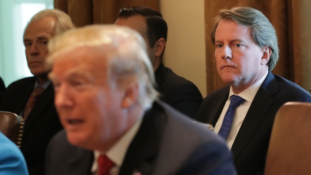 Former White House Counsel Don McGahn, right, stares at President Donald Trump during a cabinet meeting at the White House.