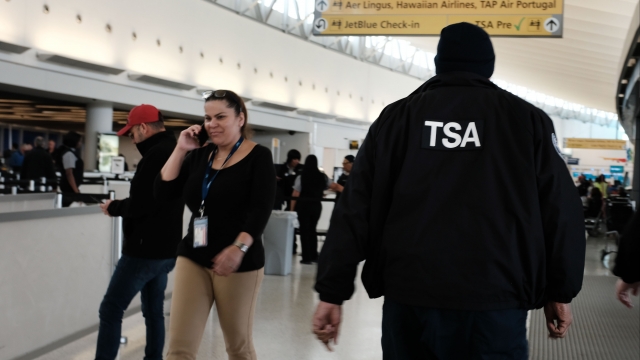 A TSA agent walks through an airport.