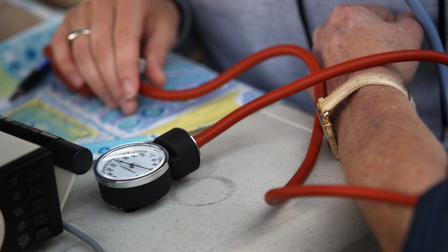 Nurse checks patient's blood pressure