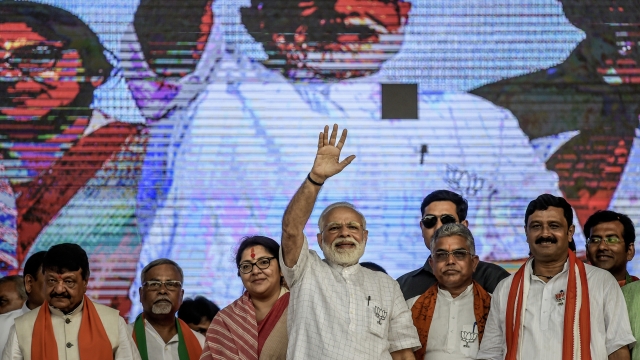 Indian Prime Minister Narendra Modi waves during a public rally