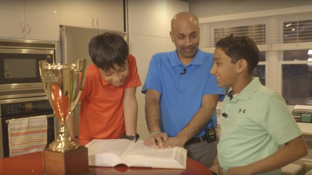 1985 Spelling Bee champion Balu Natarajan reads the dictionary with his sons
