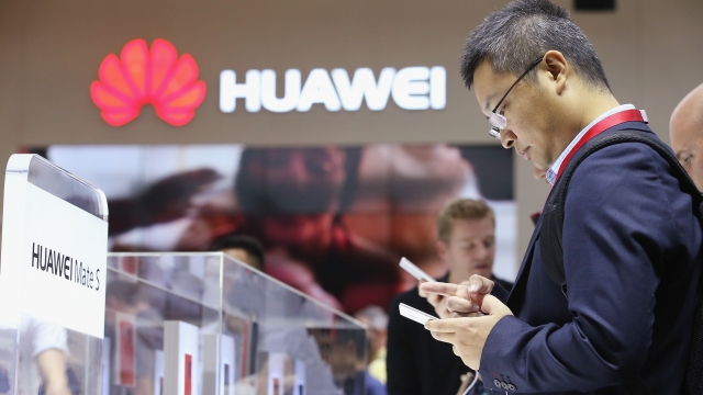 Visitors try out Huawei technology at a consumer electronics show